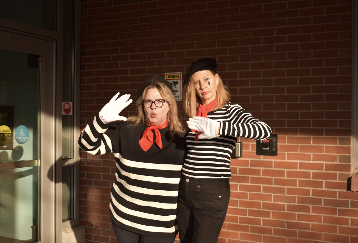  Fine Arts teachers, Rachel Carroll (left) and Susan Memoli (right) freeze for a photo in their mime costumes. This year, the Fine Arts department coordinated their Halloween look to embody their theatrical roots.